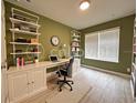Modern office space with built-in shelving, a spacious desk, and ample natural light from a large window at 2741 Nottel Dr, St Cloud, FL 34772