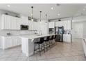 Spacious modern kitchen with white cabinets, stainless steel appliances, and large center island at 2965 Slough Creek Dr, Kissimmee, FL 34744