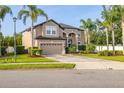 Tan two story home with mature landscaping and a two car garage at 305 Kays Landing Dr, Sanford, FL 32771