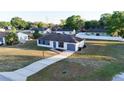 Aerial view of a cozy home with an inviting driveway and a lush green neighborhood at 312 Oak Track Ter, Ocala, FL 34472