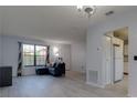 Bright living room featuring modern vinyl floors, neutral paint, and large windows at 312 Oak Track Ter, Ocala, FL 34472