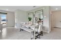 Open dining room featuring tile floors, modern decor, a dining table set for six, and natural light at 3449 Briarwood Grove Dr, Ocoee, FL 34761