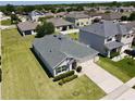 Wide shot of a home showing its well-maintained lawn, modern roof, and proximity to a Gathering-friendly neighborhood at 3702 Maidencain St, Clermont, FL 34714