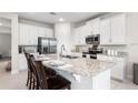 Modern kitchen features stainless steel appliances and a granite island at 416 Southfield St, Kissimmee, FL 34747