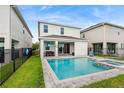 Backyard features a sparkling pool and spa with a black fence at 416 Southfield St, Kissimmee, FL 34747