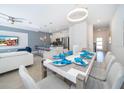Spacious, open-concept living area featuring modern decor, a dining table, and easy access to kitchen at 4188 Paragraph Dr, Kissimmee, FL 34746
