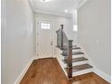Welcoming foyer with hardwood floors, stairs, and a white front door, offering a bright entrance at 441 N Capen Ave, Winter Park, FL 32789