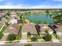 Aerial view of beautiful homes surrounding a lake, showcasing the well-manicured lawns and a serene neighborhood setting at 459 Dancing Water Dr, Winter Springs, FL 32708