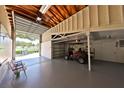 Spacious garage with high ceilings, offering ample room for parking and storage with a golf cart at 505 S Cooper St, New Smyrna Beach, FL 32169