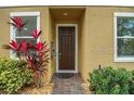 Inviting home entrance featuring a classic front door, manicured shrubbery, and a well-maintained walkway at 6863 Tussilago Way, Orlando, FL 32822