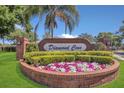 Diamond Cove community entrance featuring colorful flowers and lush landscaping under clear blue skies at 8061 Bangle Ln, Orlando, FL 32836