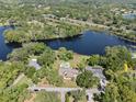 High aerial view of a lakeside neighborhood with mature trees and a swimming pool at 29 Windsor Isle Dr, Longwood, FL 32779