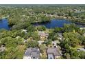 High aerial view of a lakeside neighborhood with mature trees and large lake at 29 Windsor Isle Dr, Longwood, FL 32779
