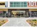 Elegant entrance to 101 EOLA featuring glass doors and modern architecture at 101 S Eola Dr # 1018, Orlando, FL 32801