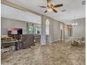Open-concept living space with tile floors, arched doorways, and ample natural light, great for entertaining at 115 Crescent Moon Dr, Groveland, FL 34736