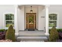Inviting front entryway with a stylish light fixture and elegant glass-paneled door at 1341 Lyndale Blvd, Winter Park, FL 32789
