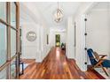 Elegant hallway features hardwood floors, archways, and modern chandelier at 1341 Lyndale Blvd, Winter Park, FL 32789