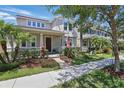Attractive two-story home with a well-manicured lawn, inviting front porch, and classic curb appeal at 14838 Bahama Swallow Blvd, Winter Garden, FL 34787