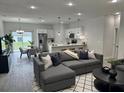 Open-concept living space featuring modern finishes, stainless steel appliances, and a cozy seating area at 15750 Sw 40Th Ter Sw 40Th Ter, Ocala, FL 34473