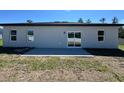 Back exterior of home with a smooth patio and sliding glass doors providing ample natural light at 15750 Sw 40Th Ter Sw 40Th Ter, Ocala, FL 34473