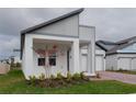 Beautiful modern home featuring a brick driveway, a two-car garage, and gray-and-white paint at 16271 Silver Grove Blvd, Winter Garden, FL 34787