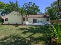 Inviting backyard with a concrete patio and beautiful landscaping and plenty of green space at 1635 Magnolia Ave, South Daytona, FL 32119