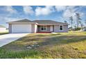 Charming single-story home featuring a two-car garage and landscaped yard at 16771 Sw 21St Terrace Rd, Ocala, FL 34473