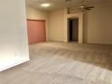 Bright living room with neutral carpeting and a sliding door to the outside at 1805 San Luis Ln, The Villages, FL 32159