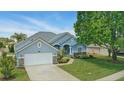 Well-maintained home with a manicured lawn, stone accents, and an attached two-car garage at 212 Hazeltine Dr, Debary, FL 32713