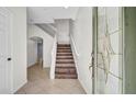 Bright foyer showcasing a staircase and tile flooring at 2167 Velvet Leaf Dr, Ocoee, FL 34761