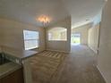 Cozy living room with carpet flooring, neutral paint, and natural light flowing in from the windows at 224 Lake Charles Dr, Davenport, FL 33837