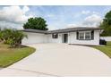 Beautiful single-story home featuring a freshly painted exterior, a well-kept lawn, and an attached garage at 2259 King Johns Ct, Winter Park, FL 32792