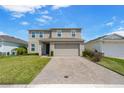 Attractive two-story home boasts a neatly paved driveway and landscaped front yard at 2730 Parkfield Rd, St Cloud, FL 34772
