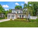Landscaped front yard featuring a modern two-story home with a two-car garage and beautiful curb appeal at 2813 Northwood Blvd, Winter Park, FL 32789