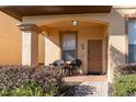 Cozy front porch with seating, manicured landscaping, and a well-maintained exterior at 309 Verona Ave, Davenport, FL 33897
