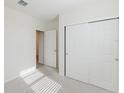 Clean, carpeted bedroom featuring closet and a doorway to another room at 349 Guadlupe St, Haines City, FL 33844