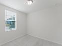 Bright, carpeted bedroom with a large window offering plenty of natural light at 349 Guadlupe St, Haines City, FL 33844