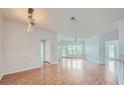 Sunlit living room featuring hardwood floors, neutral walls, and access to a balcony at 3621 Conroy Rd # 738, Orlando, FL 32839