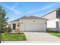Charming single-Gathering home featuring a two-car garage, complemented by a well-maintained lawn and landscape at 4224 Pebbles Throw Dr, Kissimmee, FL 34746