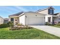 Charming single-Gathering home featuring a two-car garage, complemented by a well-maintained lawn and landscape at 4224 Pebbles Throw Dr, Kissimmee, FL 34746