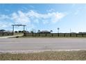 A long driveway leads to a house with a windmill and a ranch entrance with longhorn skull overhead at 4400 Walker Lake Rd, Bartow, FL 33830