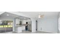 Modern kitchen featuring stainless steel appliances, granite countertops, and grey tile flooring at 51 Park Ln, Debary, FL 32713