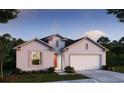 Charming single-story home featuring a two-car garage, well-manicured lawn, and neutral color palette at 6635 Lullaby Way, Mascotte, FL 34753