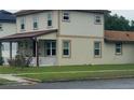Side view of a two-story house displaying clean lines and a well-maintained yard at 900 S Maple Ave, Sanford, FL 32771