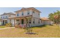 Well-maintained two-story home with a tidy yard, side-entry garage, and welcoming front porch at 900 S Maple Ave, Sanford, FL 32771