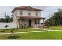 Inviting two-story home with a well-kept lawn and welcoming front porch at 900 S Maple Ave, Sanford, FL 32771