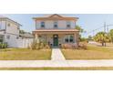 Inviting two-story home with a cozy front porch and lush green lawn at 900 S Maple Ave, Sanford, FL 32771