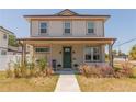 Charming two-story home with a welcoming front porch and manicured landscaping at 900 S Maple Ave, Sanford, FL 32771
