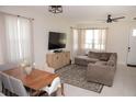 Bright living room featuring a sectional sofa, dining table, and large windows at 900 S Maple Ave, Sanford, FL 32771