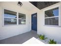 Stylish front door entrance with modern tiles, fresh landscaping, and natural light at 1148 Martin L King Dr, Orlando, FL 32805